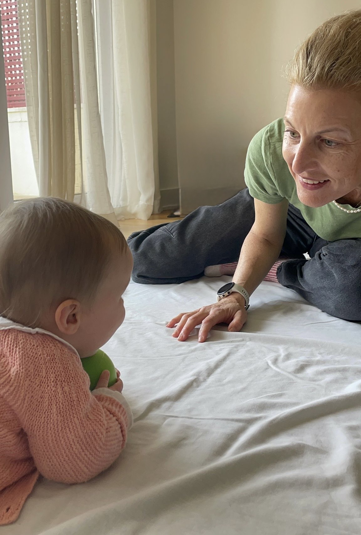 Naomi engaging with a baby during a private session